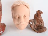 three clay heads sitting next to each other on a table