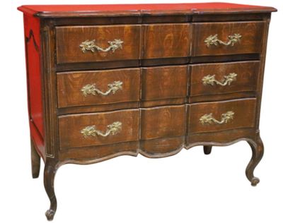 a chest of drawers with a red top and gold handles