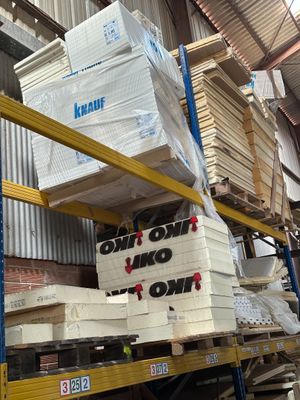 boxes are stacked on a pallet in a warehouse with a sign that says don ' t stop now