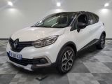 a white car parked on a checkered floor in a garage