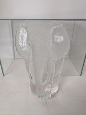 a glass vase with an elephant inside of it