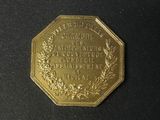 an image of a gold coin with a wreath on it