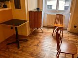 two chairs and a table in a room with a window