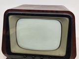 a small television sitting on top of a white table