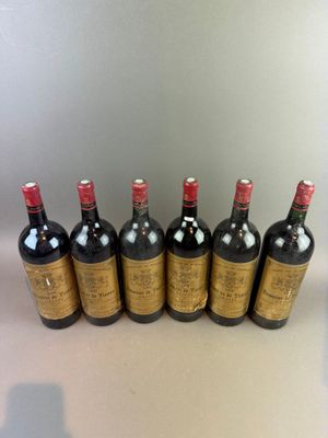 six bottles of wine are lined up in a row on a table