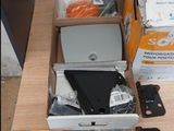 a box of electronic equipment on a table next to a box of other items