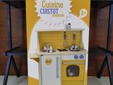 a cardboard box with a yellow and white kitchen set in it