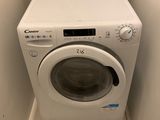 a white washer and dryer in a small room