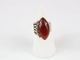 a close up of a ring with a red stone on it