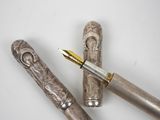two pens sitting next to each other on a table
