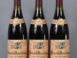 three bottles of wine are lined up on a table