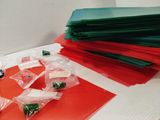 a pile of red and green plastic bags on a table