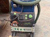 a machine that is sitting on the ground with a hose