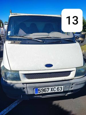 a white van parked in a parking lot with a number 13 on the front