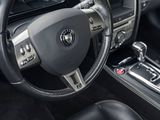 the interior of a car with a steering wheel and dashboard controls