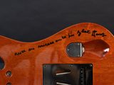 an image of a close up of a guitar with a note on it