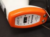 an orange and white device sitting on a black surface