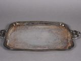 a silver tray with handles and handles on a gray surface