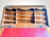 an old wooden desk with a red mat on it