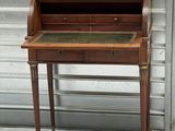 an antique writing desk with a marble top and brass hardware