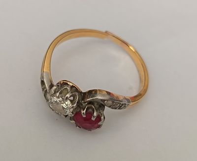 gros plan d'une bague en or avec une pierre rouge