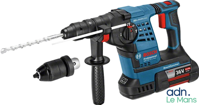 a close up of a corded hammer with a drill attached to it