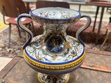 a blue and white vase sitting on top of a table