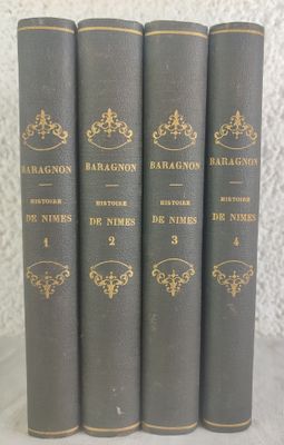four books are lined up in a row on a table