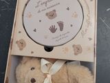 a teddy bear that is in a box on the floor