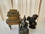 three statues sitting on a table next to a piano