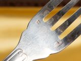 a fork that is sitting on top of a yellow plate