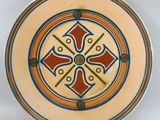 a plate with a design on it on a white surface