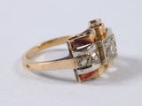 an image of a gold ring with three diamonds on it