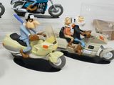 three figurines of people riding motorcycles and a motorcycle