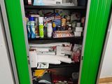 a green cabinet that has a lot of items in it