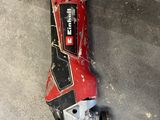 a red and black skateboard laying on the ground