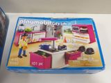 a box with a playmobil kitchen set inside of it