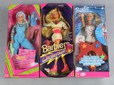 three barbie dolls are in their boxes on a table