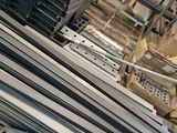 several pieces of metal are stacked on top of each other in a warehouse