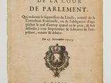 a close up of an old book with a crown on it