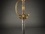 a gold and silver sword on a black background