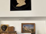 a picture of a statue of a man on a shelf in a room