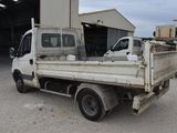 a white truck parked in front of a building