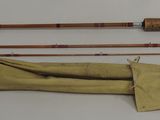 an image of a pair of fishing rods and a bag on a table