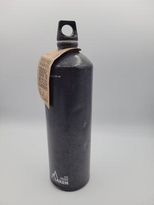a black water bottle sitting on top of a white table