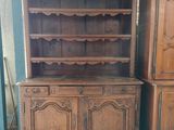 two wooden cabinets and a cupboard in a room