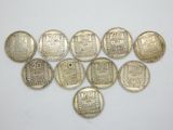a bunch of coins sitting on top of a white surface