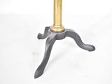 a small table with a gold top on a white background