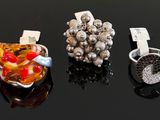 three different rings are sitting on a table with a black background