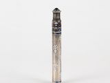 a silver pen that is sitting on a white surface
